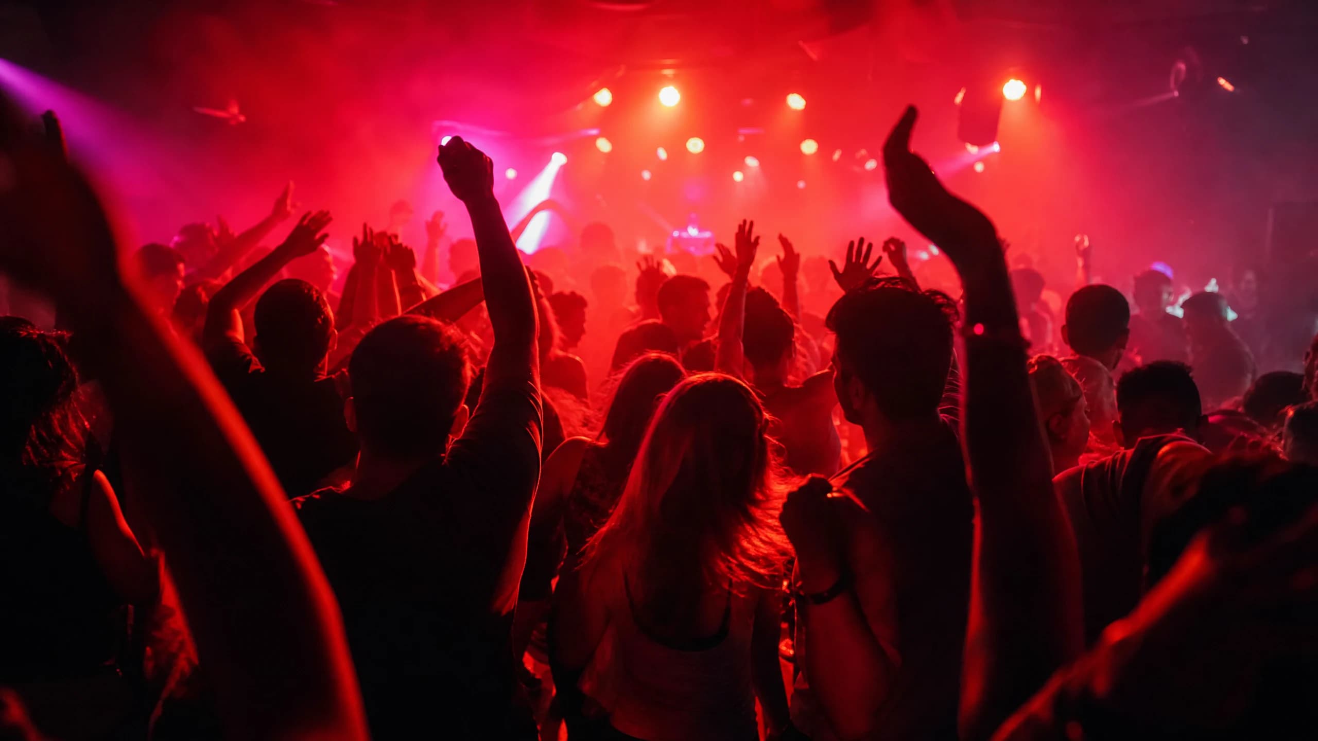 Dancing crowd in a red-lit club