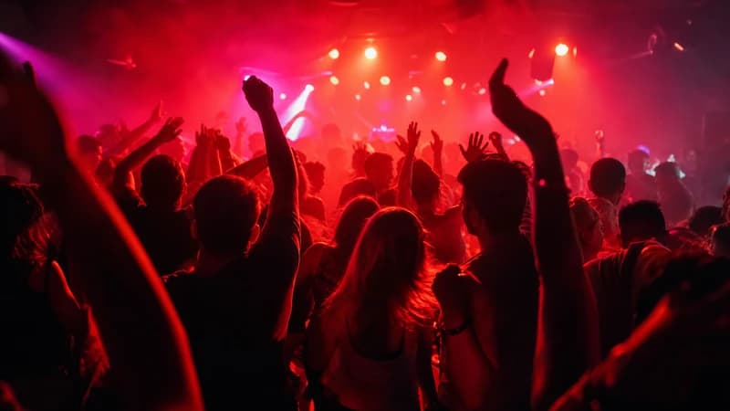 Dancing crowd in a red-lit club